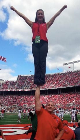 Ohio State cheer coach Ben Schreiber stunting at tOSU Alumni Day.